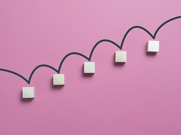 five ascending white blocks connected by dark line against a pink background